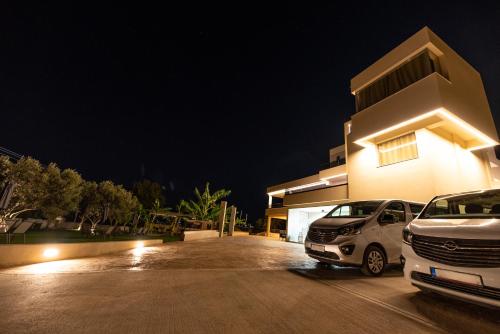 two cars parked in a parking lot in front of a building at Airscape Hotel Free Shuttle From And To Athen's Airport in Artemida