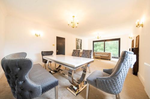 a dining room with a table and chairs at House on the Hill in Harrow on the Hill