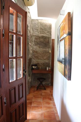 a hallway with a door and a table at Vale de Rans - Country House in Rans