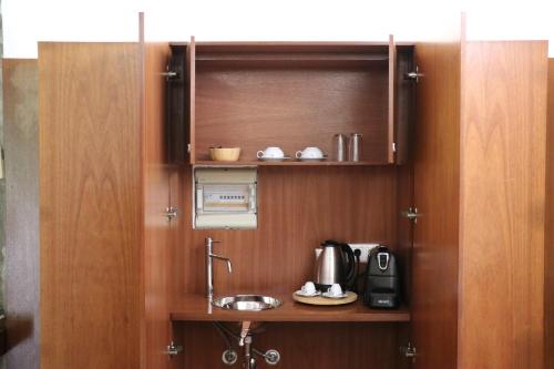 a small kitchen with a sink and a microwave at Vale de Rans - Country House in Rans