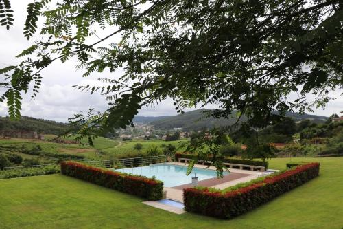 a swimming pool in the middle of a green yard at Vale de Rans - Country House in Rans