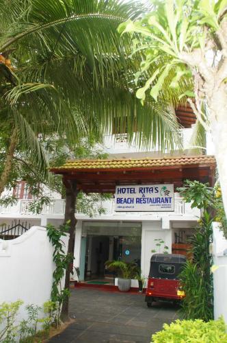 a building with a sign that reads hotel lifts of each restaurant at Ritas Hotel in Hikkaduwa