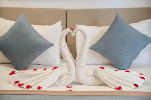 two swans towels sitting on a bed with pillows at Riad Atlas Palace & SPA in Marrakech