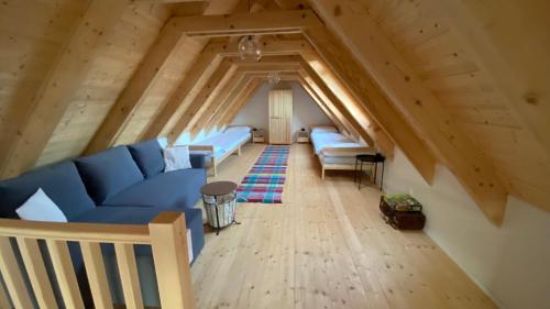 a living room with blue couches in an attic at Rusínska chyža in Ulič