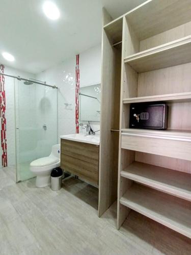 a bathroom with a toilet and a sink and a shower at Hotel Kaamú Taganga in Taganga