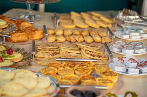 a buffet of pastries and other pastries and pies at Riad Atlas Palace & SPA in Marrakech