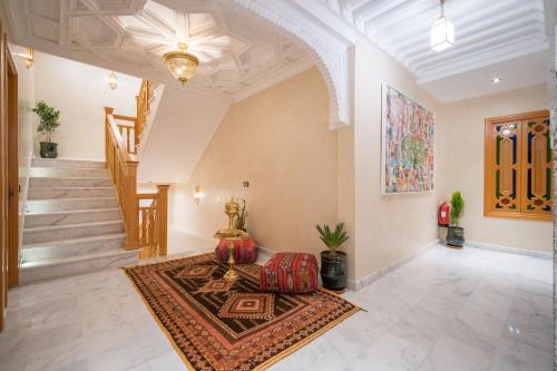 a living room with a couch and a staircase at Riad Atlas Palace & SPA in Marrakech