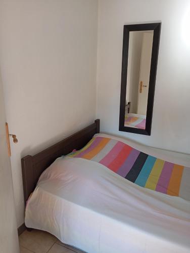a bedroom with a bed with a mirror on the wall at Appartement dans Villa à marignane in Marignane