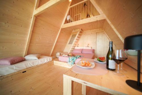 a room with a couch and a table with a wine glass at Glamping Fonte Murata in Portoferraio