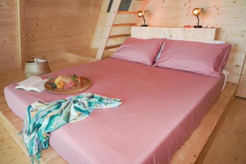 a large bed with a plate of food on it at Glamping Fonte Murata in Portoferraio