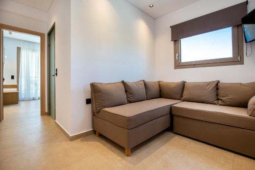 a couch in a living room with a window at Calma Living in Potos