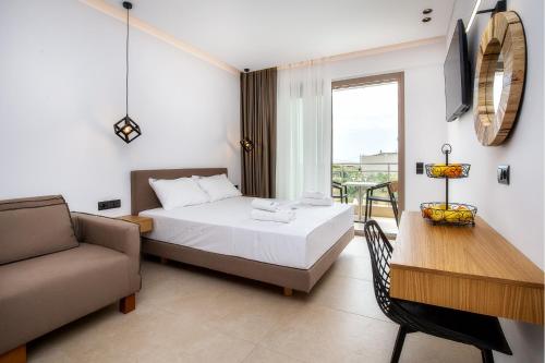 a bedroom with a bed and a couch and a table at Calma Living in Potos