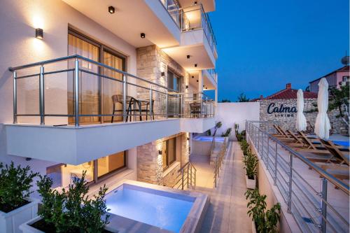 a balcony of a building with a swimming pool at Calma Living in Potos