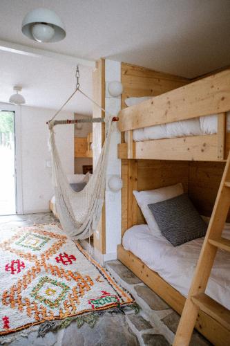 a bedroom with two bunk beds and a hammock at VILLA Centre Guethary piscine acces ocean a pied in Guéthary