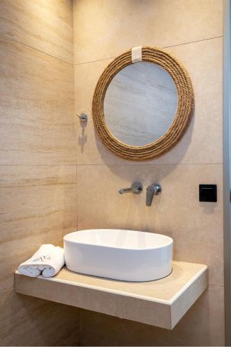 a bathroom with a white sink and a mirror at Calma Living in Potos