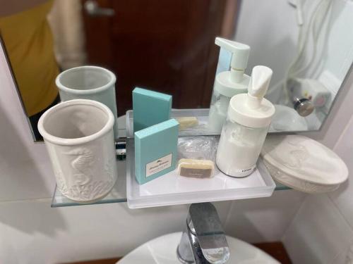 a shelf with bathroom items on it in front of a mirror at Beautiful and peaceful 2-bedroom family condo in Juan Dolio