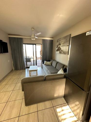 a living room with a couch and a table at Tranquility - Banana Beach Club in Port Shepstone
