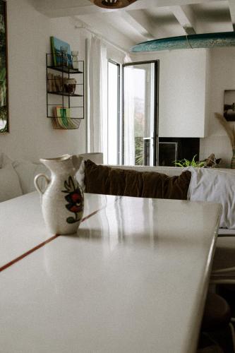 a vase sitting on a table in a living room at VILLA Centre Guethary piscine acces ocean a pied in Guéthary