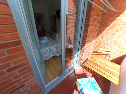 a sliding glass door to a balcony with a bench at Pensión La Estación in Logroño
