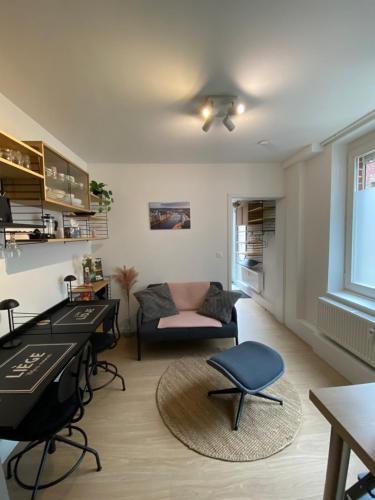 a living room with a piano and a couch at Sweet Home in Liège