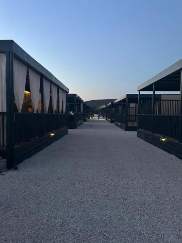 a row of huts on the beach at dusk at Mobile Home Sea Breeze in Sveti Petar