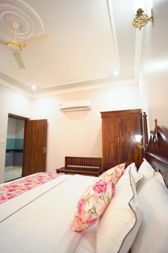 a bedroom with a bed with a wooden headboard and pillows at Chitawa Haveli jaipur in Jaipur