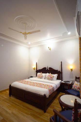 a bedroom with a large bed and a couch at Chitawa Haveli jaipur in Jaipur