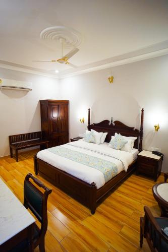 a bedroom with a large bed and wooden floors at Chitawa Haveli jaipur in Jaipur