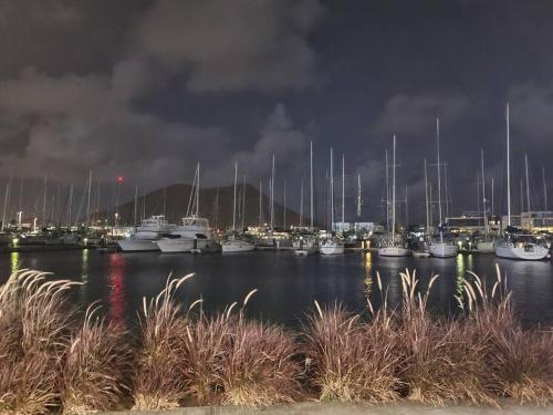 a group of boats docked in a marina at night at Private villa with large pool & 5min walk to beach in Cap Estate