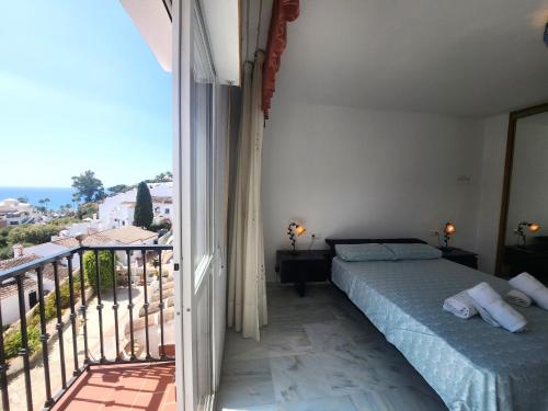 a bedroom with a bed and a balcony at Villa Pinomar - Sleeps 8 - Burriana Beach in Nerja
