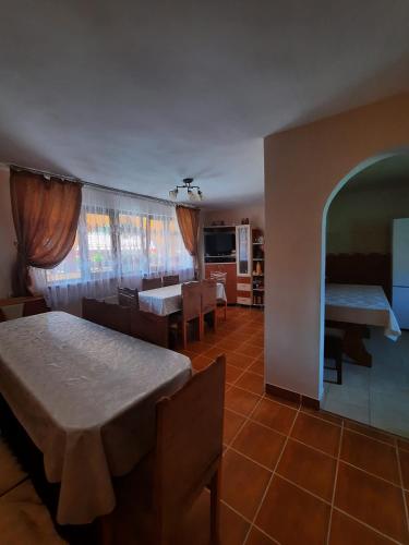 a living room with a table and a dining room at Casa ALINA ȘI ANDREEA in Arieşeni
