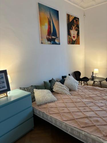 a bed in a room with posters on the wall at Art of Sopot in Sopot