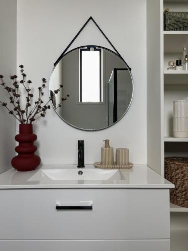 a bathroom sink with a large mirror on the wall at New York Minute in Temuka