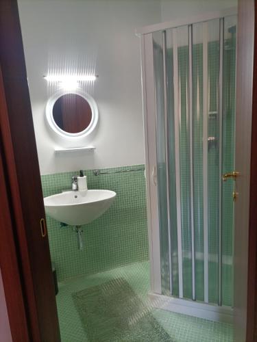 a bathroom with a sink and a glass shower at B&B Marilyn house in Caserta