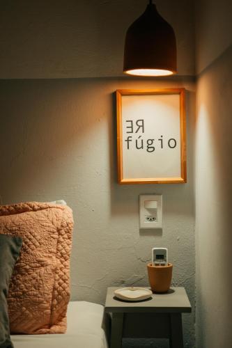 a room with a bed and a table with a lamp at Pousada Girassol Morro de São Paulo in Morro de São Paulo