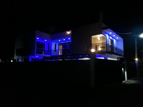 a house with blue lights on it at night at SRG Villa in Grand Baie