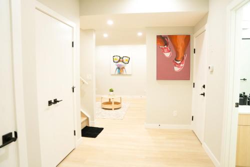 a hallway of a home with white walls at The Old Trafford - Stylish 2 bed suite in Calgary