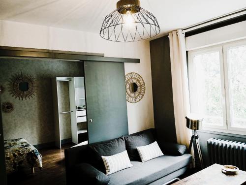 a living room with a couch and a mirror at Appartement hyper centre 3 Lorient in Lorient