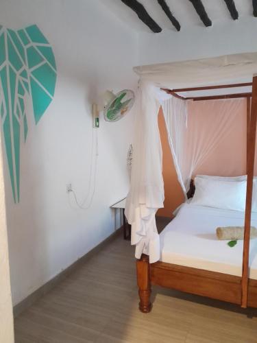 Postel nebo postele na pokoji v ubytování Nyumbani Hostel