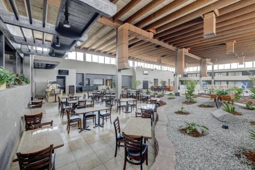 a restaurant with tables and chairs in a building at Riverside Hotel in Casper