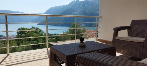 a balcony with a table and a view of a mountain at Tamaris apartments Risan in Risan
