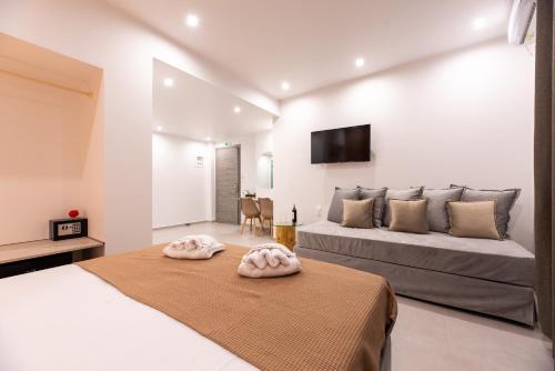 a bedroom with two beds and a flat screen tv at Airscape Hotel Free Shuttle From And To Athen's Airport in Artemida