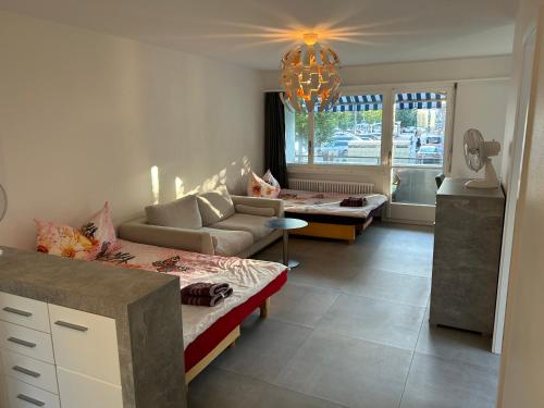 a living room with two beds and a couch at HANNA Apartment in Interlaken
