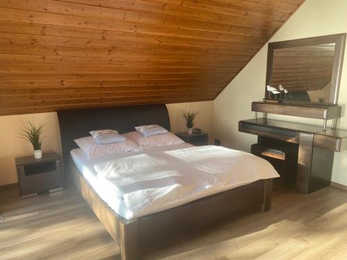 a bedroom with a large bed and a piano at Jarski Domek in Stężyca