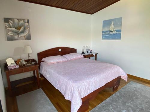 a bedroom with a bed with a pink bedspread at APARTMENT KORI in Baška