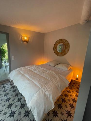 a bedroom with a large white bed and a mirror at Villa OASIS en Provence Luberon Pierrevert in Pierrevert