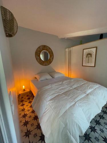 a bedroom with a white bed and a mirror at Villa OASIS en Provence Luberon Pierrevert in Pierrevert