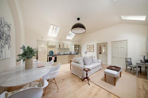 a living room with a white couch and a table at The Motor House in Newcastle upon Tyne