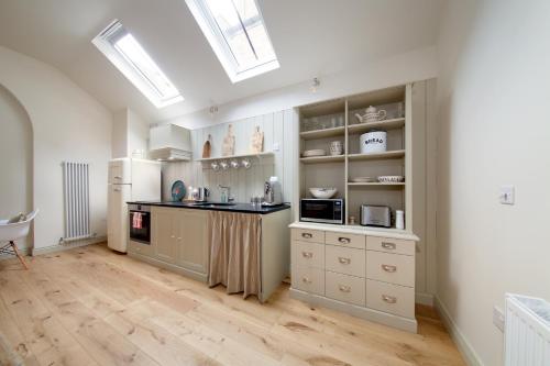 a kitchen with white cabinets and a counter top at The Motor House in Newcastle upon Tyne