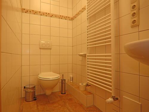 a small bathroom with a toilet and a sink at Alt Krassow Lakeside Retreat in Krassow